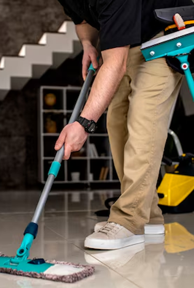Man mopping floor, shows his reflection on the floor