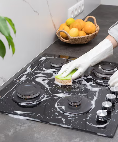Cleaning Stove with soap and sponge