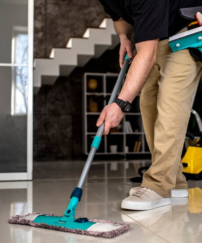 Man mopping floor, shows his reflection on the floor